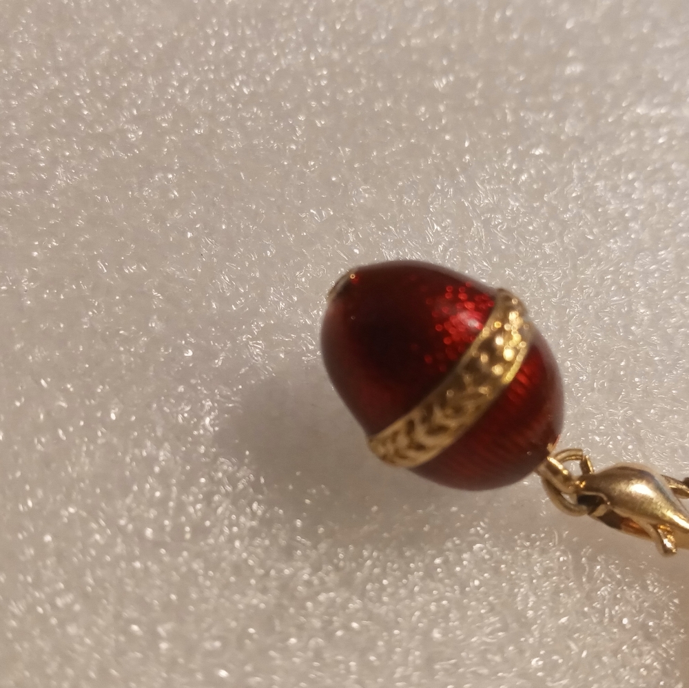 Faberge egg charm bracelet on a gold tone rolo chain. - Picture 11 of 16